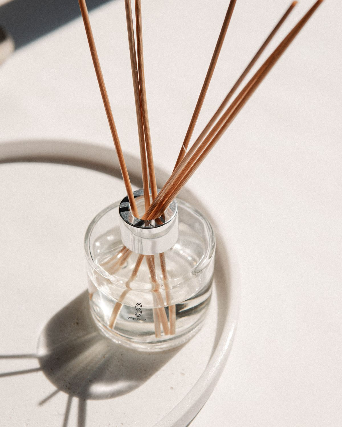 Reed diffuser placed in a refined hospitality suite.